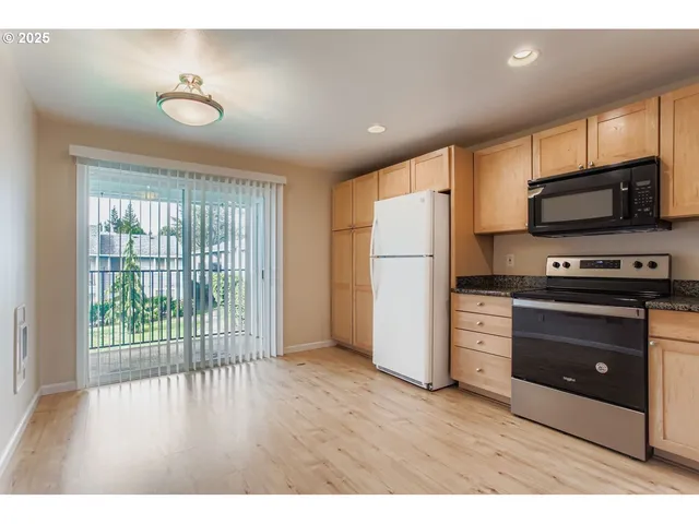 a kitchen with stainless steel appliances a refrigerator and a stove top oven