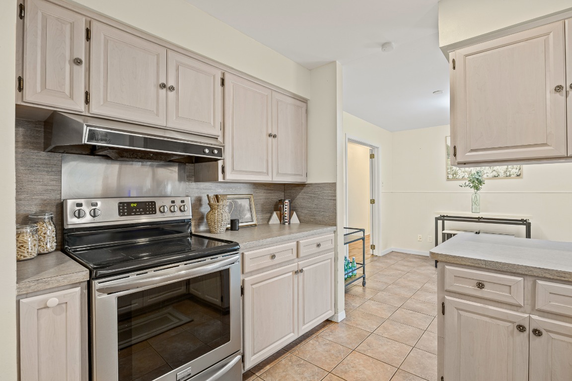 3205 Whites Drive Austin, TX 78735 - Photo 11 of 31 a kitchen with white cabinets and appliances