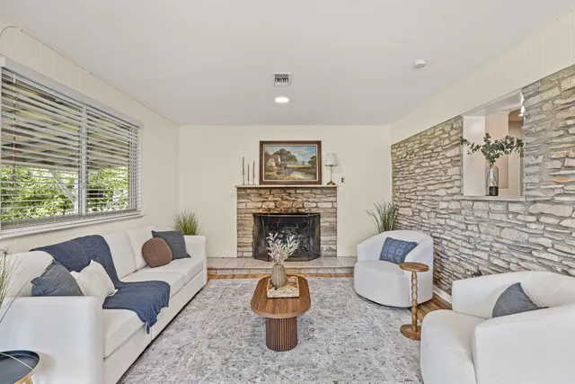 a living room with furniture and a fireplace