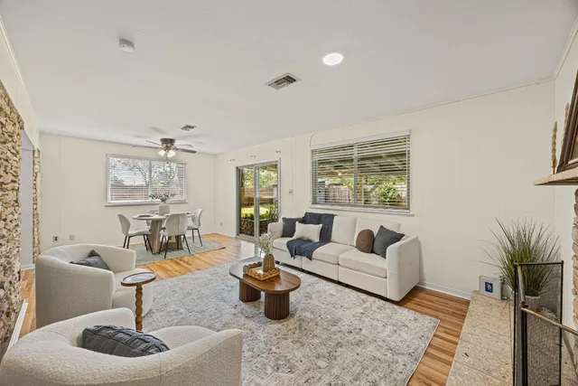 a living room with furniture and a potted plant