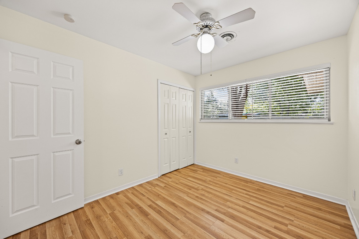 3205 Whites Drive Austin, TX 78735 - Photo 19 of 31 a view of empty room with wooden floor and fan