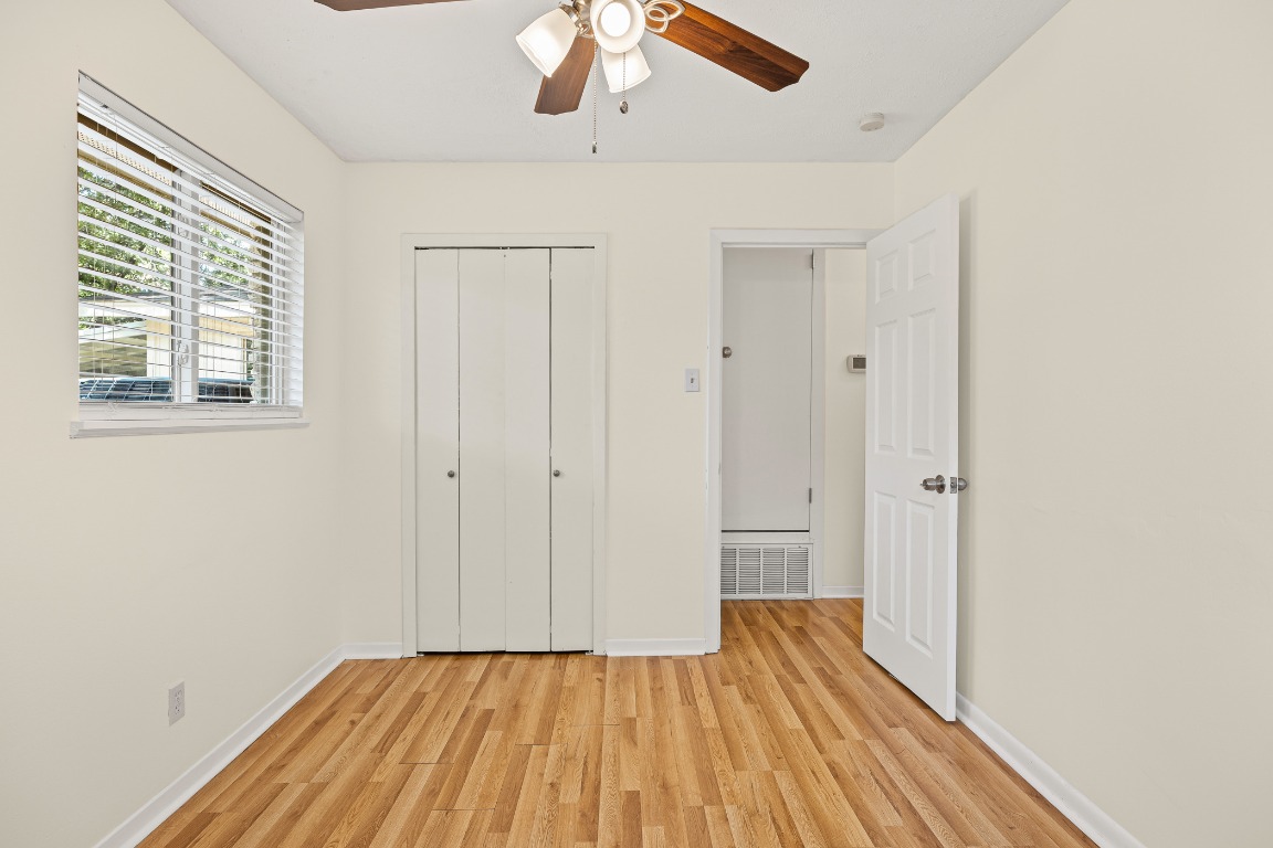 3205 Whites Drive Austin, TX 78735 - Photo 21 of 31 a view of a room with wooden floor closet and a ceiling fan