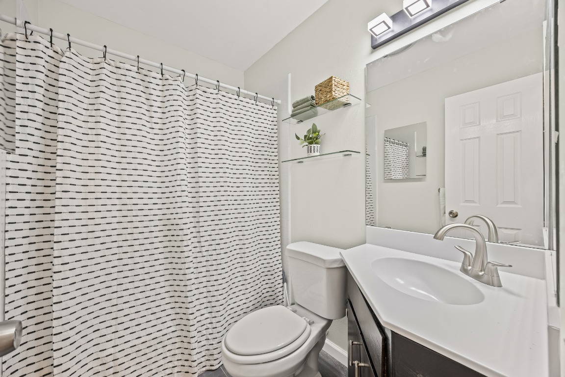 3205 Whites Drive Austin, TX 78735 - Photo 22 of 31 a white toilet sitting next to a bathroom sink