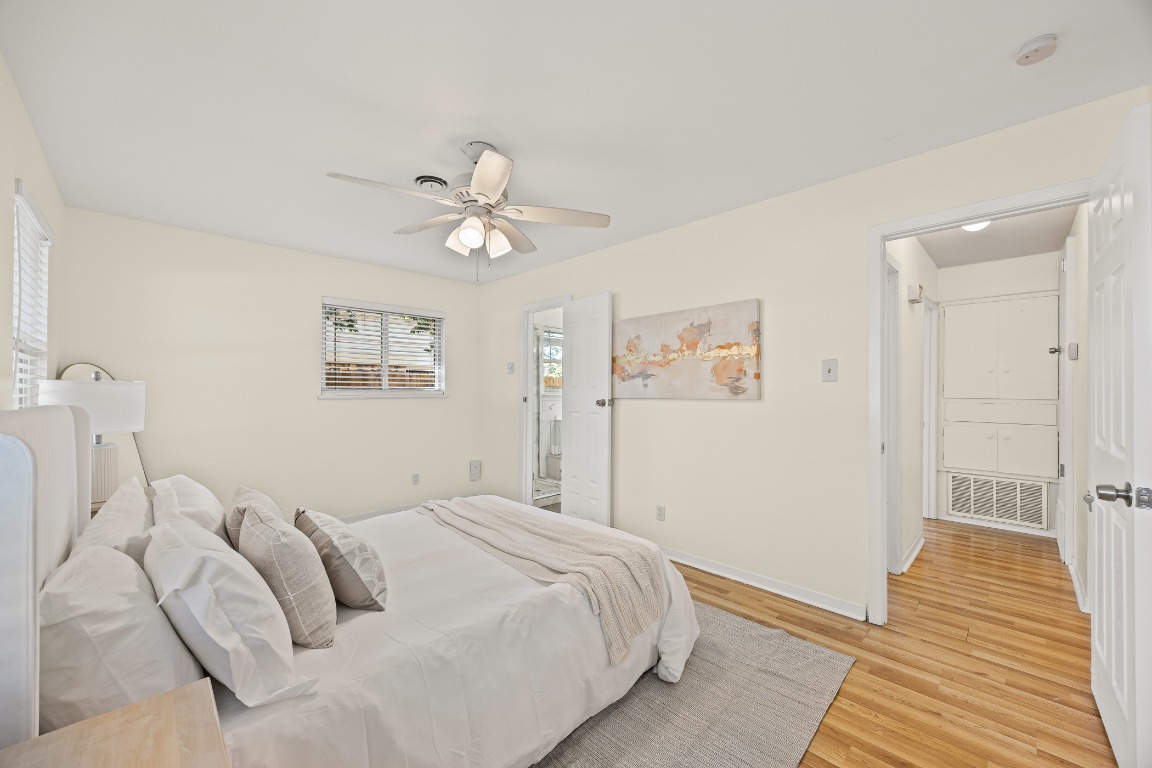 3205 Whites Drive Austin, TX 78735 - Photo 24 of 31 a bedroom with a large bed and a chandelier