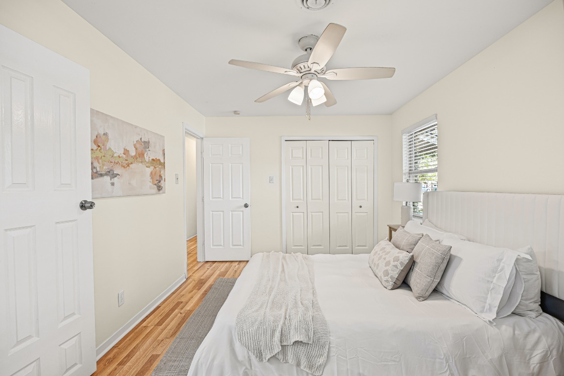 3205 Whites Drive Austin, TX 78735 - Photo 25 of 31 a bedroom with a large bed and a chandelier