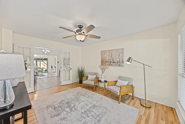 a living room with furniture and a wooden floor