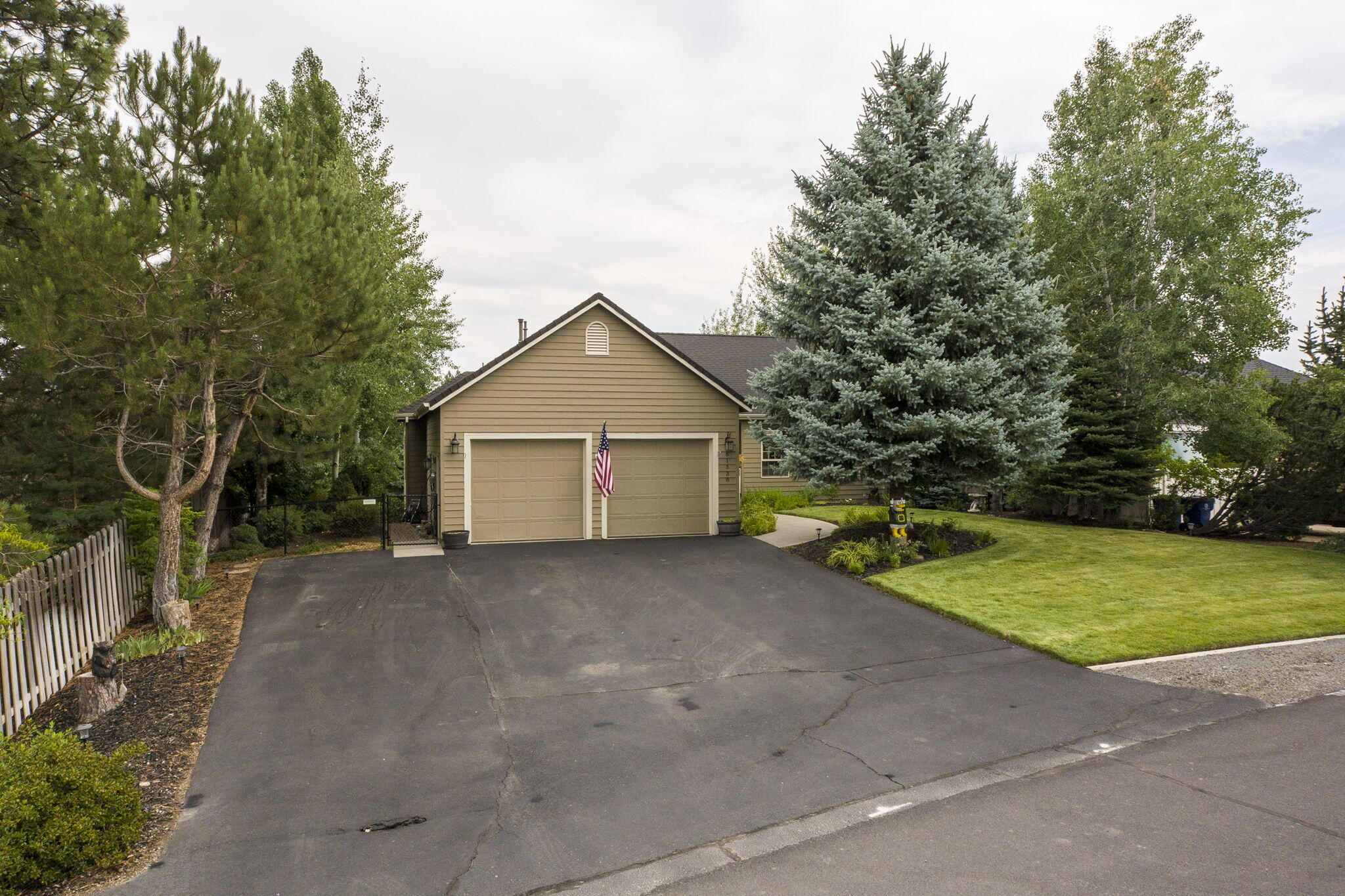 61538 Southeast Hill Ridge Road Bend, OR 97702 - Photo 57 of 59 a view of a house with a yard and large trees