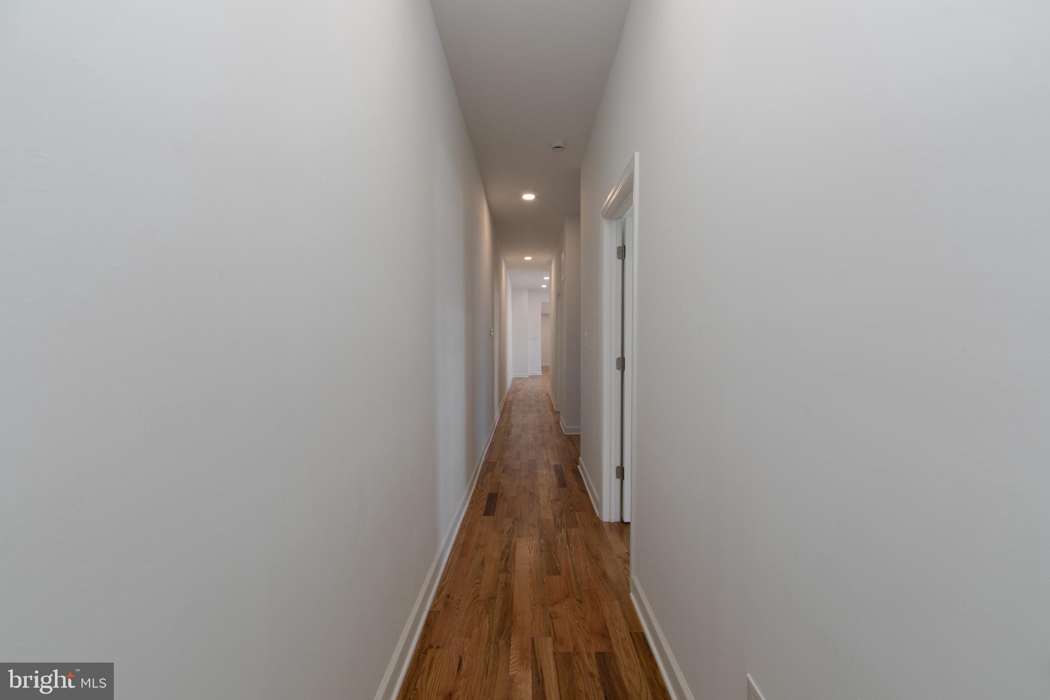 117 West Nicholson Road Audubon, NJ 08106 - Photo 18 of 32 a view of a hallway with wooden floor and a bathroom