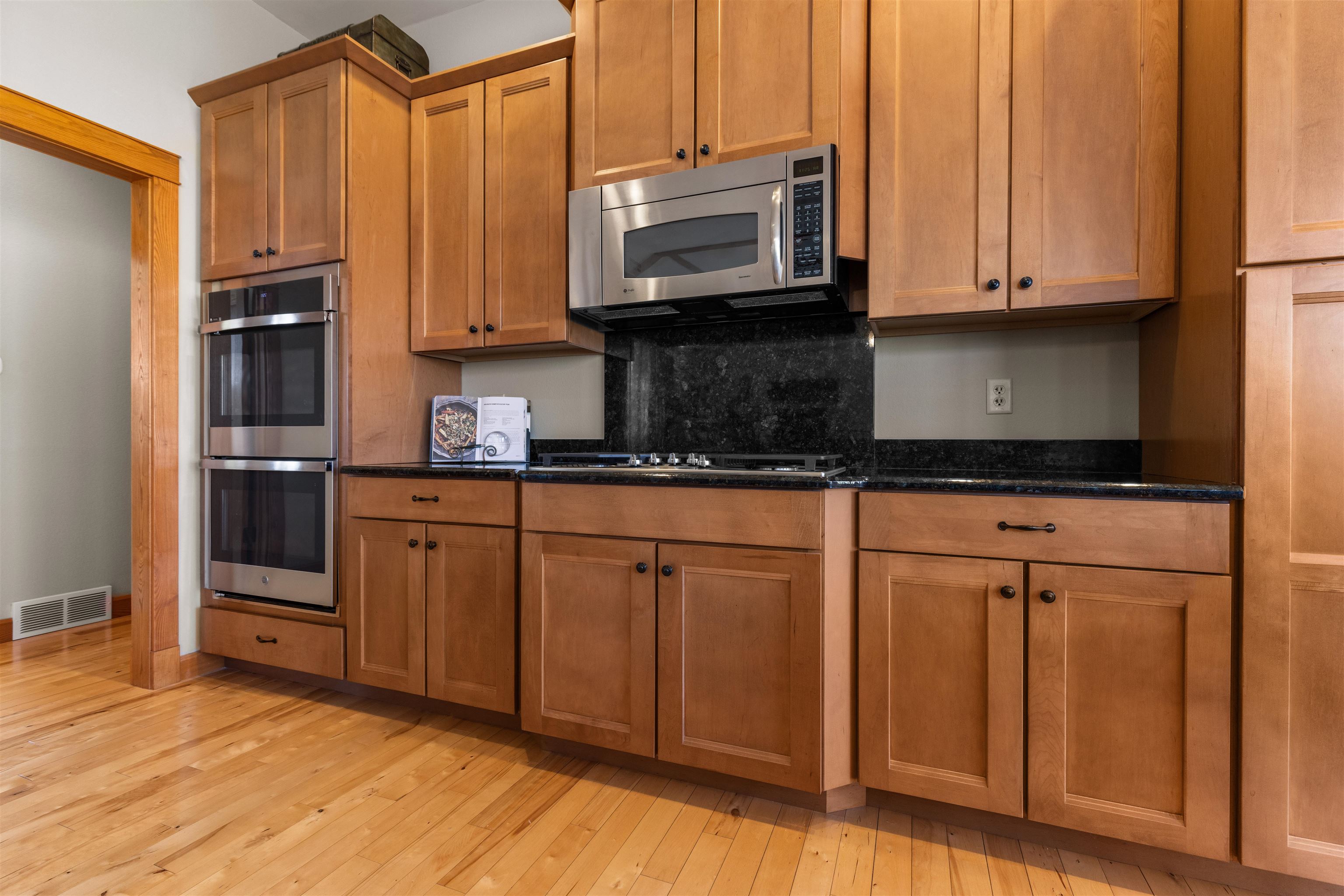 978 Weatherfield Way Belvidere, IL 61008 - Photo 12 of 41 a kitchen with stainless steel appliances granite countertop a stove a microwave and a sink