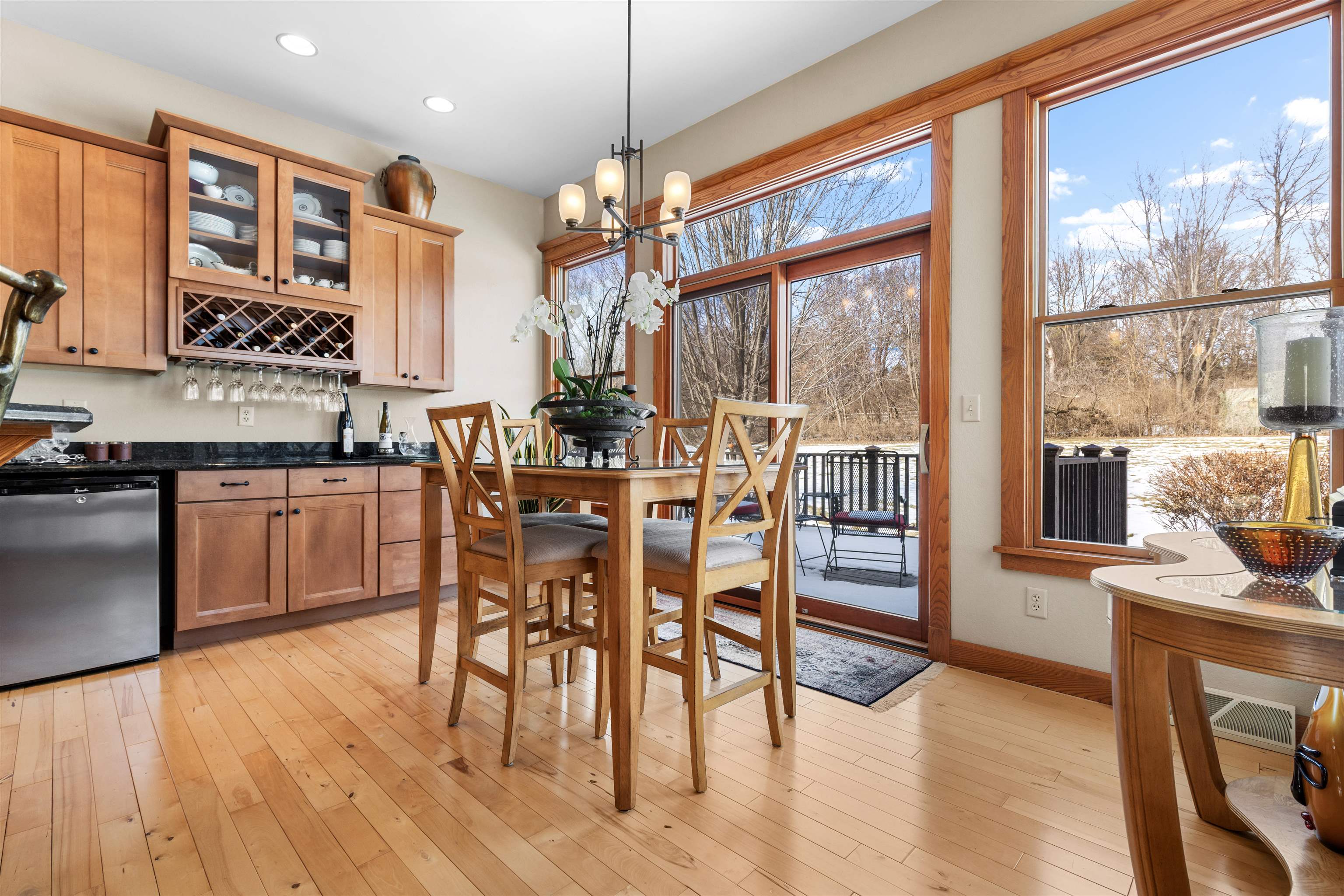 978 Weatherfield Way Belvidere, IL 61008 - Photo 13 of 41 a open kitchen with stainless steel appliances granite countertop a stove top oven a dining table and chairs with wooden floor