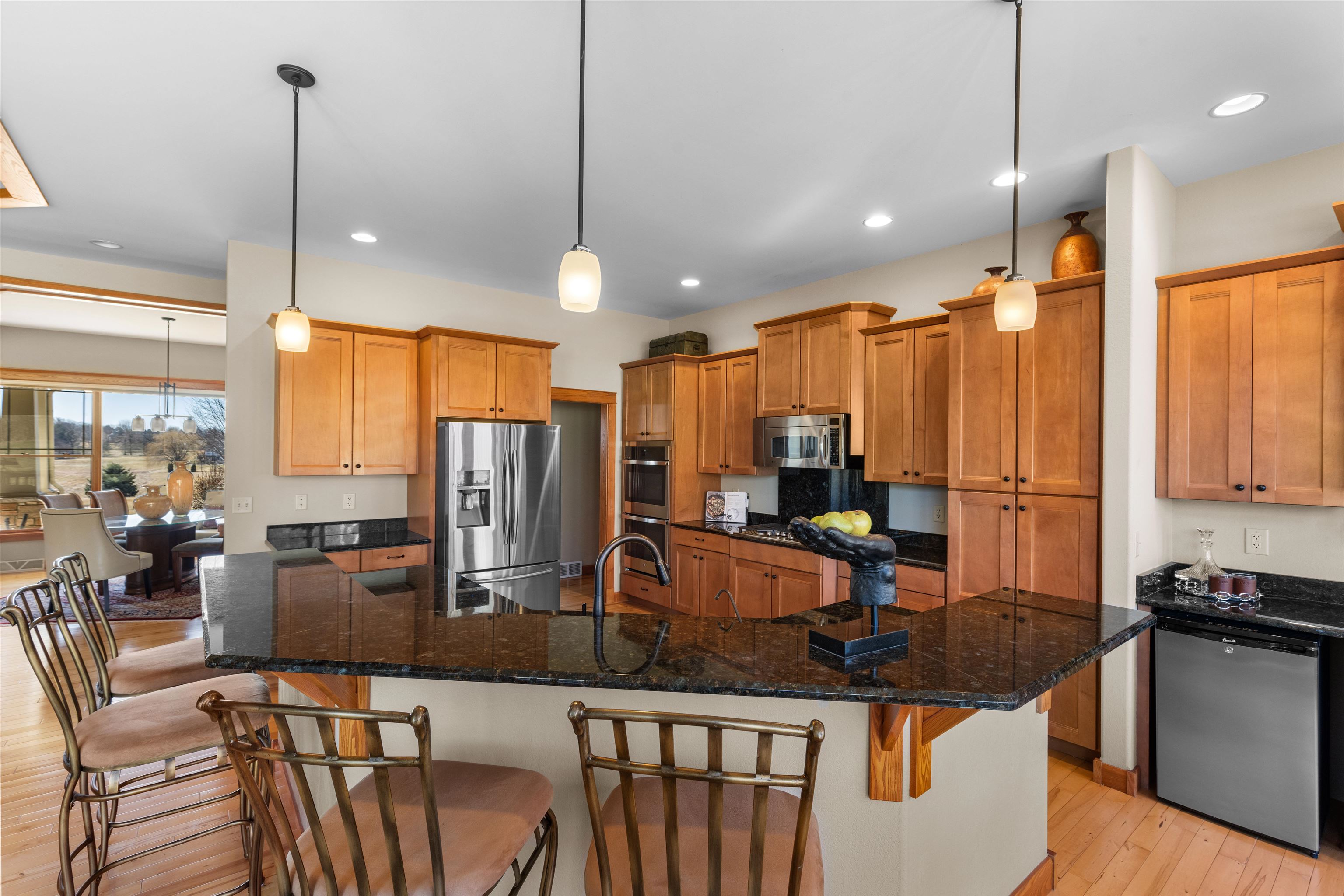 978 Weatherfield Way Belvidere, IL 61008 - Photo 9 of 41 a kitchen with stainless steel appliances granite countertop a kitchen island a stove and a refrigerator