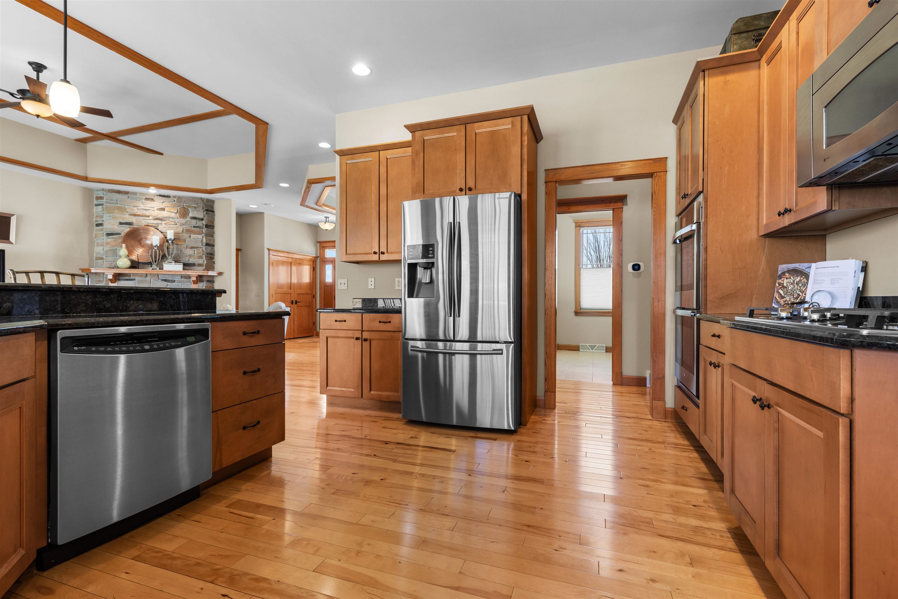 978 Weatherfield Way Belvidere, IL 61008 - Photo 10 of 41 a kitchen with stainless steel appliances a refrigerator stove and wooden floor