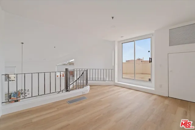 a view of an empty room and wooden floor