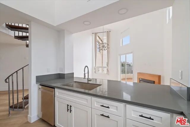 a kitchen with sink and cabinets