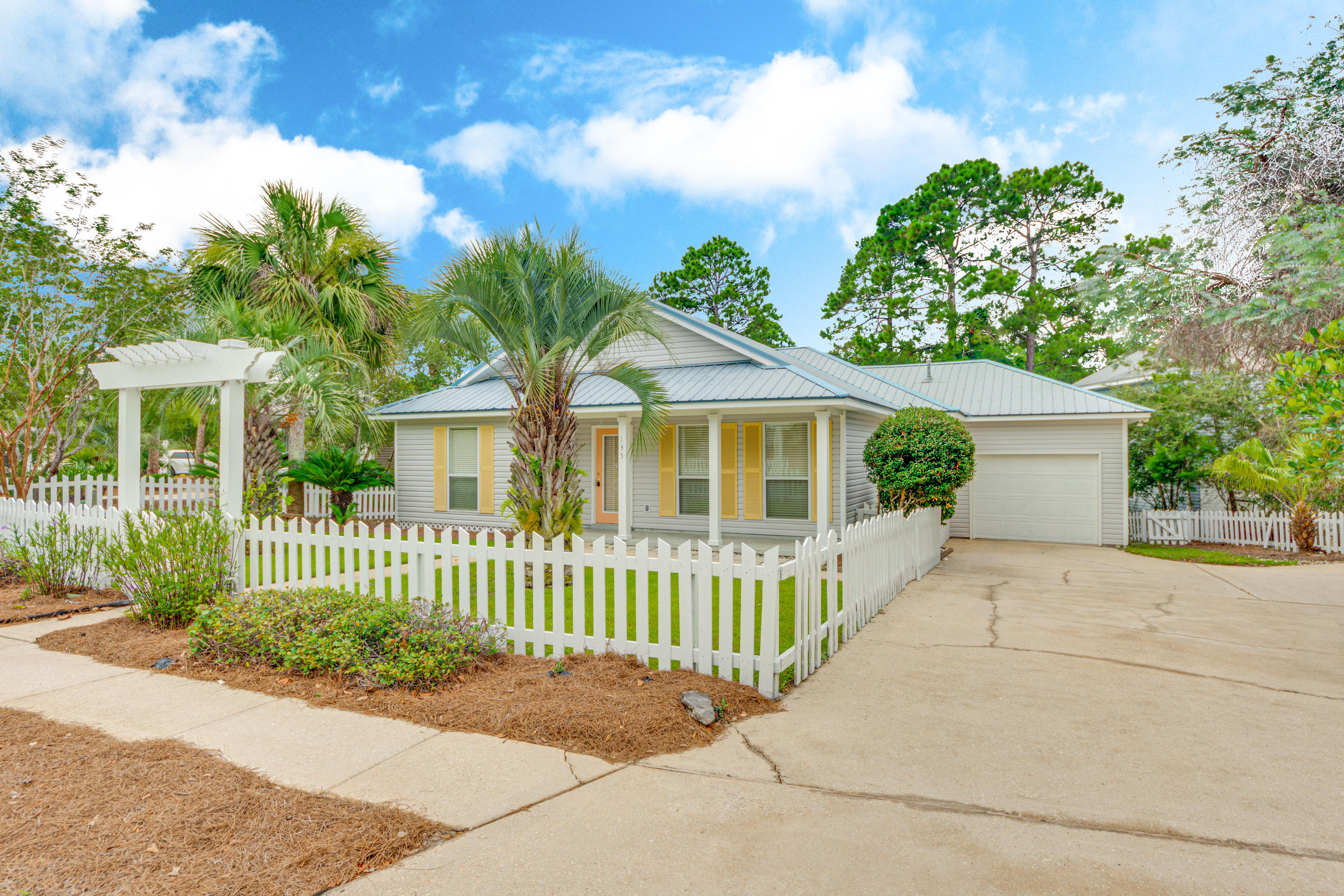 a front view of a house with a garden