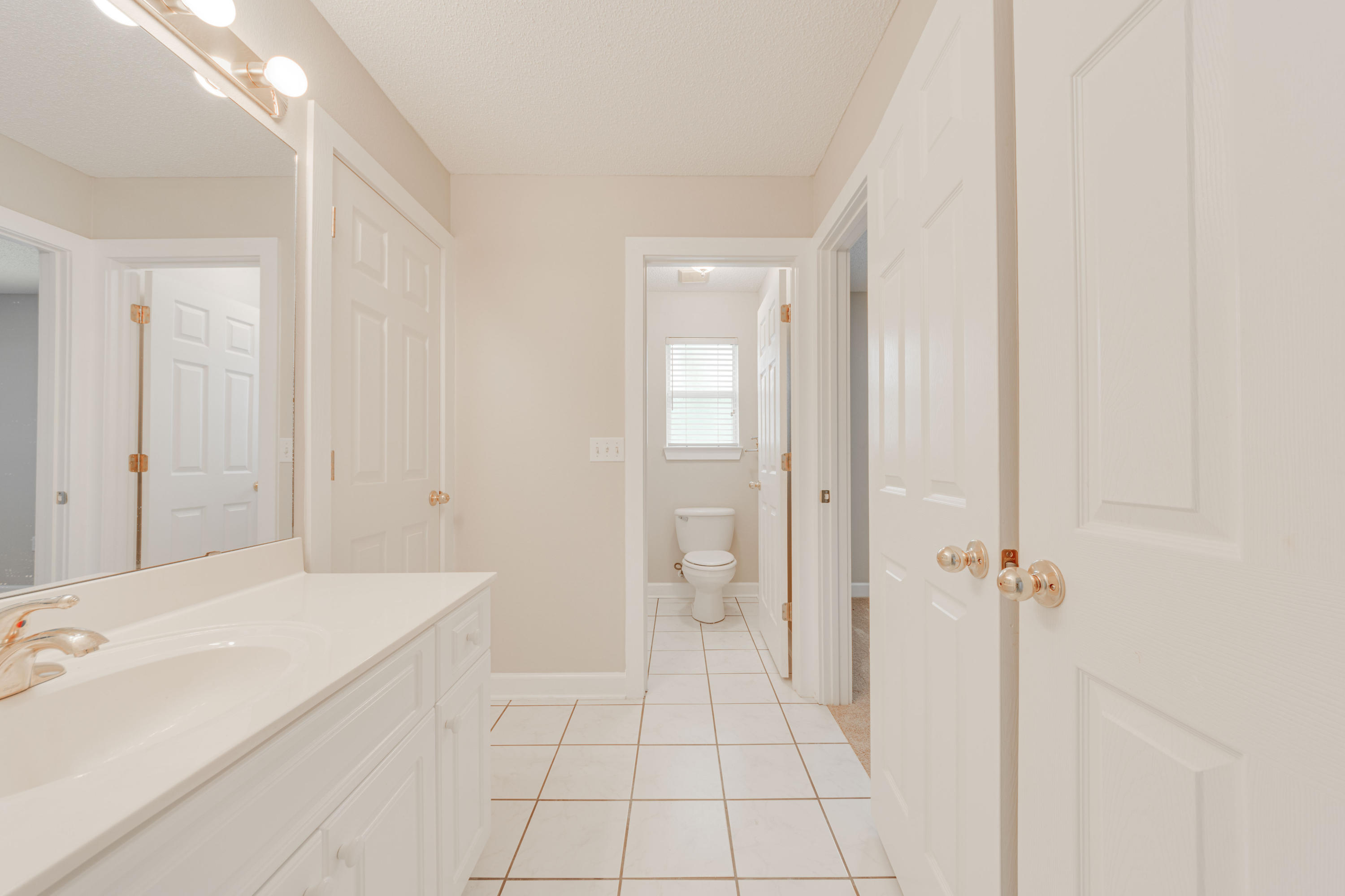 135 Gulfwinds Way Santa Rosa Beach, FL 32459 - Photo 12 of 51 a spacious bathroom with a granite countertop sink a toilet and shower