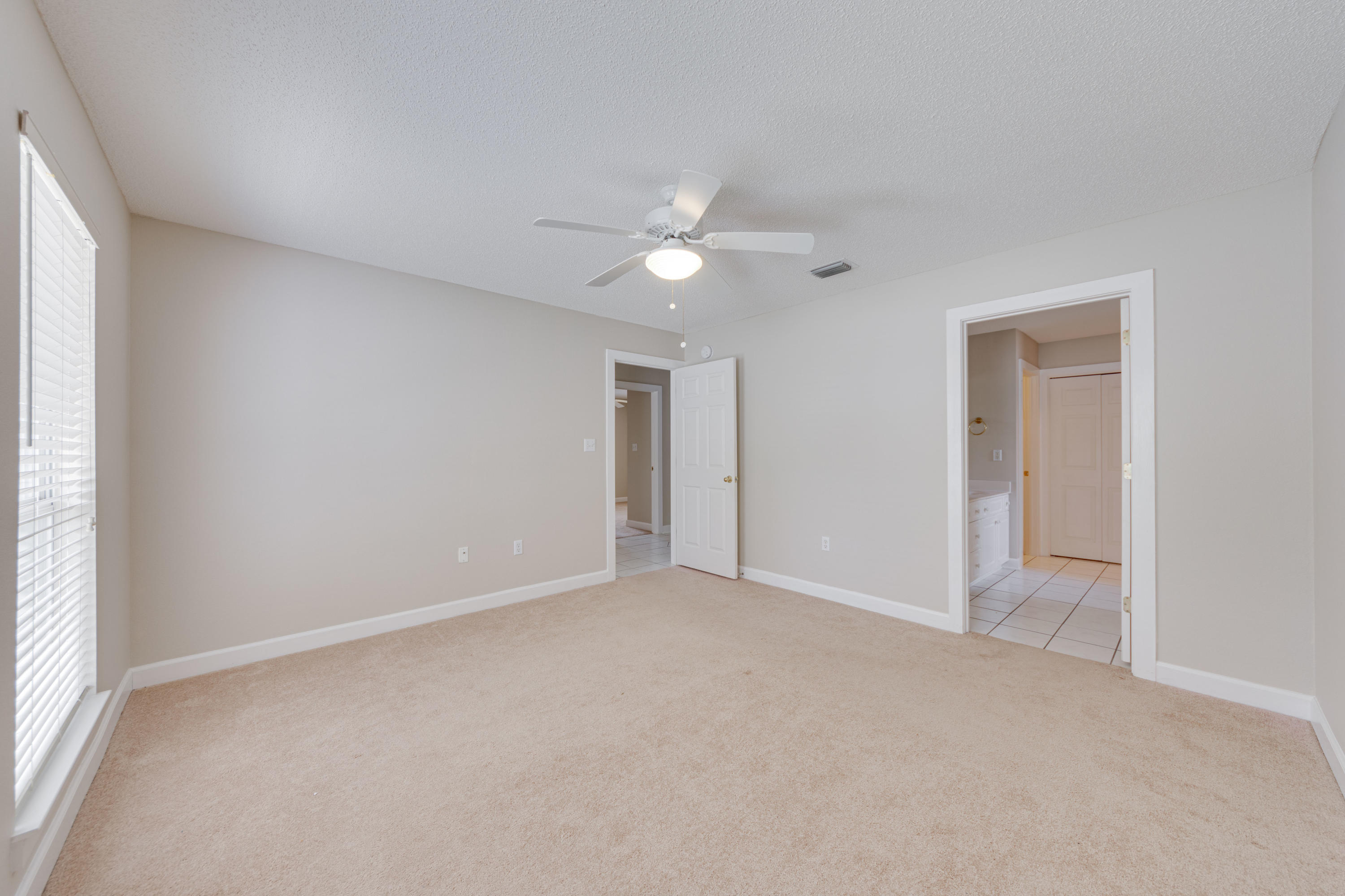 135 Gulfwinds Way Santa Rosa Beach, FL 32459 - Photo 17 of 51 an empty room with a ceiling fan and a window