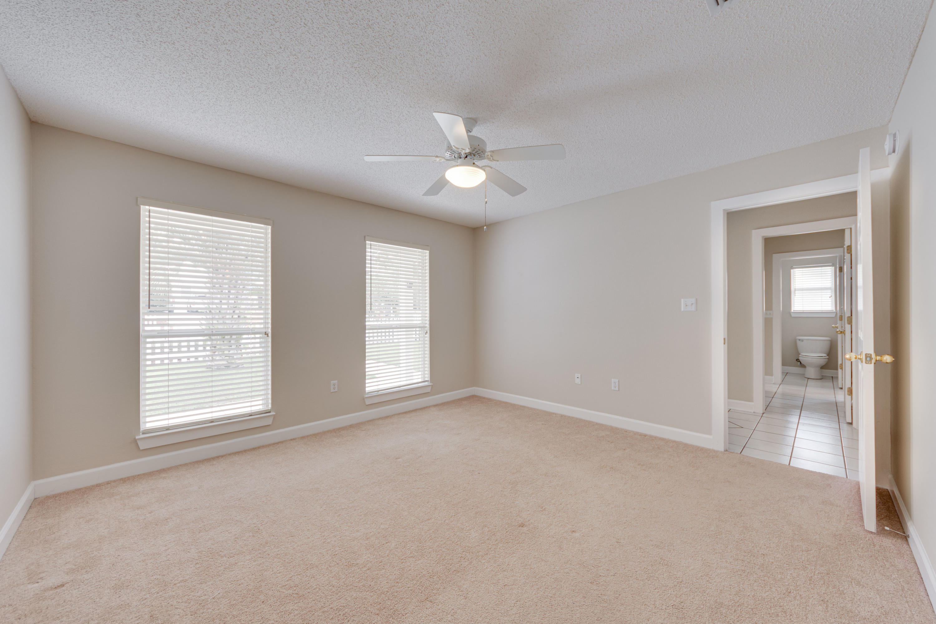 135 Gulfwinds Way Santa Rosa Beach, FL 32459 - Photo 18 of 51 an empty room with chandelier fan and windows
