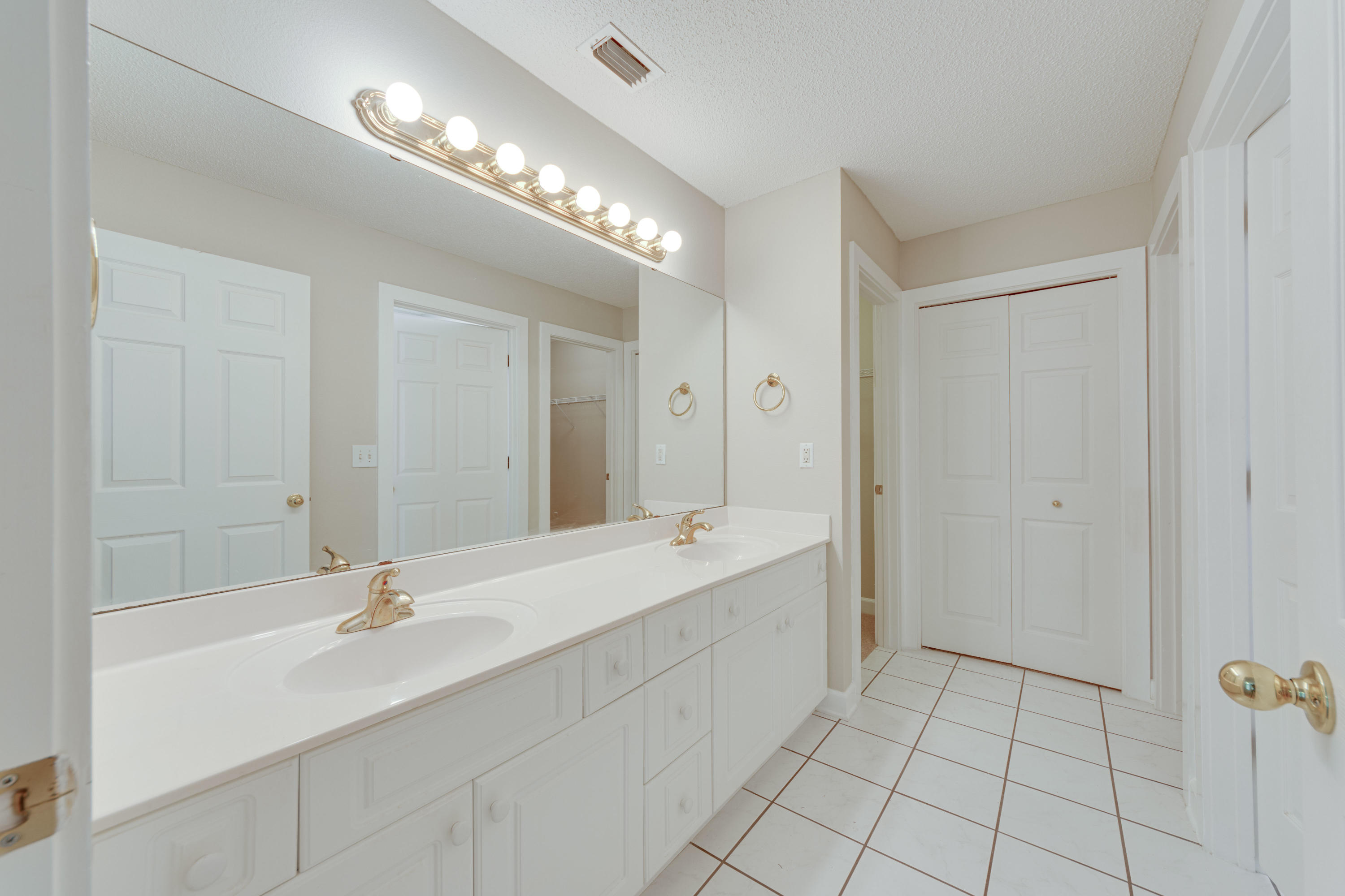 135 Gulfwinds Way Santa Rosa Beach, FL 32459 - Photo 20 of 51 a bathroom with a double vanity sink a mirror and a bathtub
