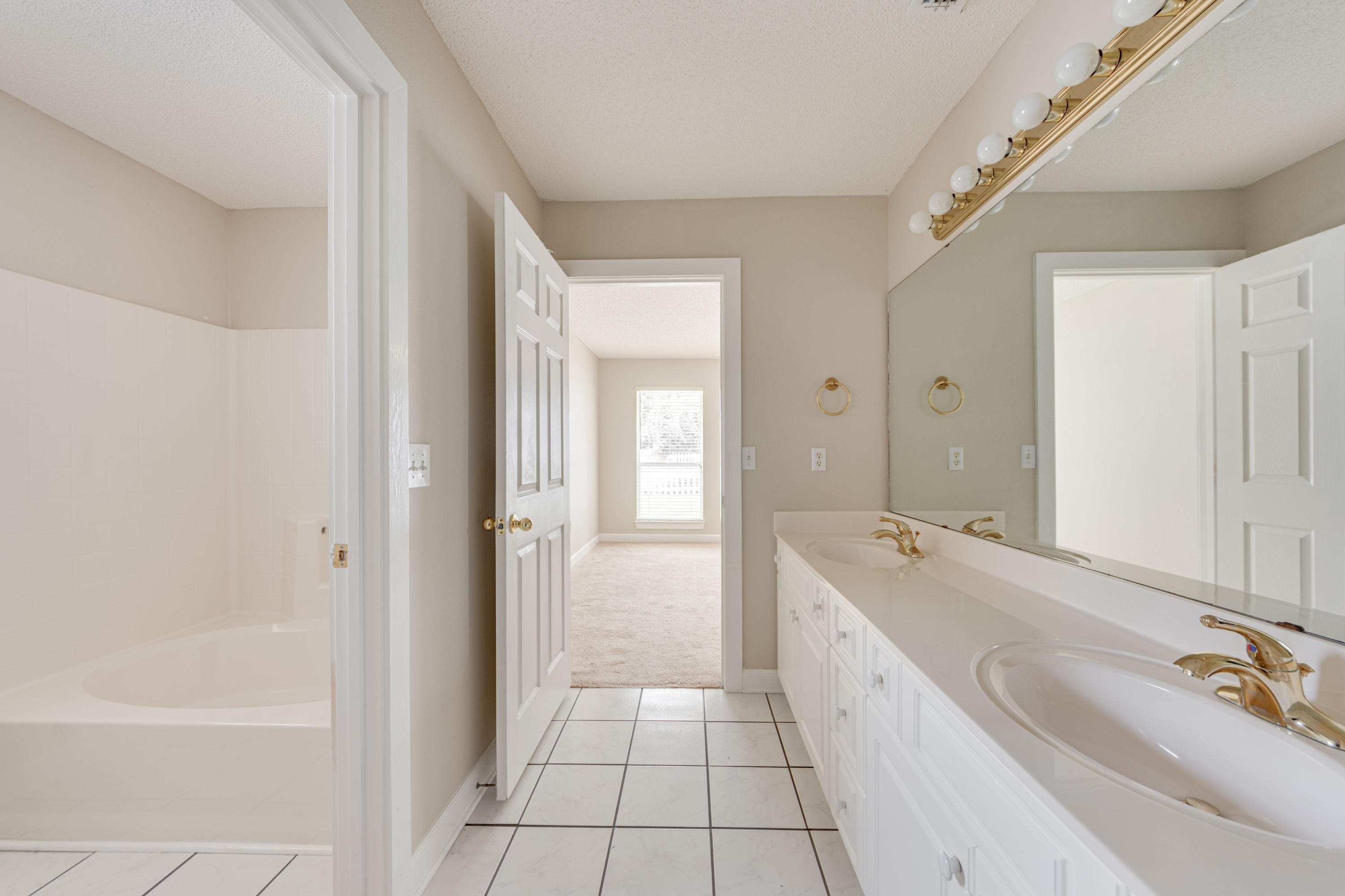 135 Gulfwinds Way Santa Rosa Beach, FL 32459 - Photo 21 of 51 a spacious bathroom with a tub sink and mirror