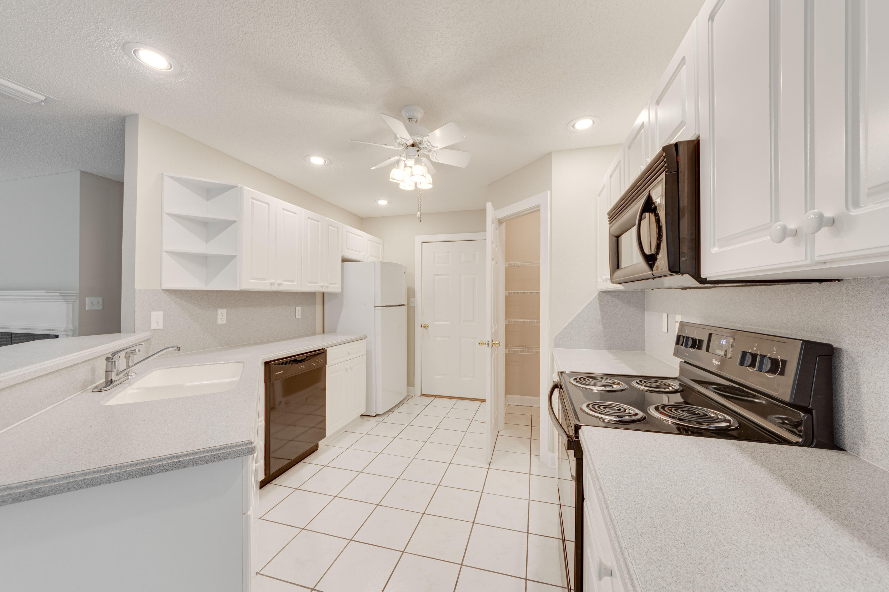 135 Gulfwinds Way Santa Rosa Beach, FL 32459 - Photo 38 of 51 a kitchen with granite countertop a sink stove and cabinets