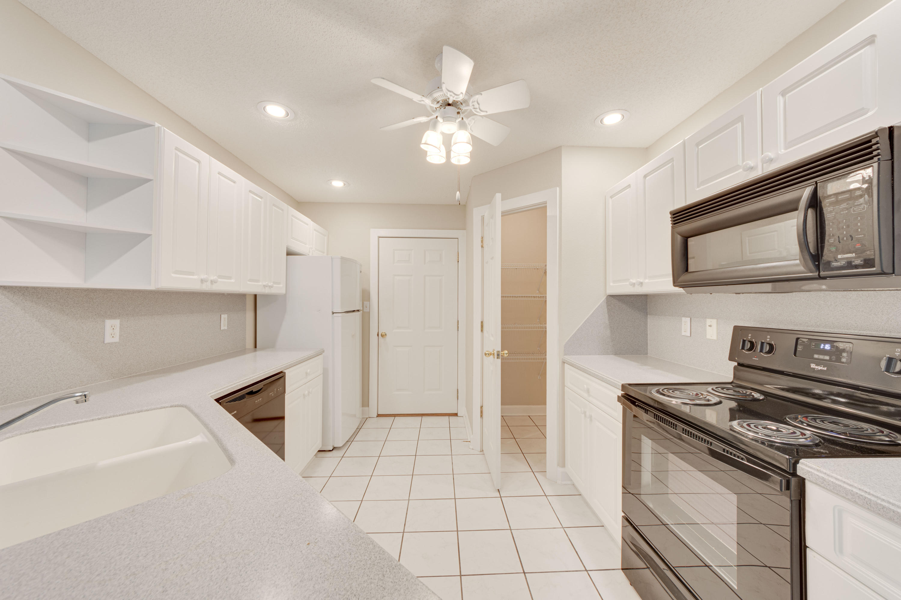 135 Gulfwinds Way Santa Rosa Beach, FL 32459 - Photo 39 of 51 a kitchen with cabinets and steel stainless steel appliances