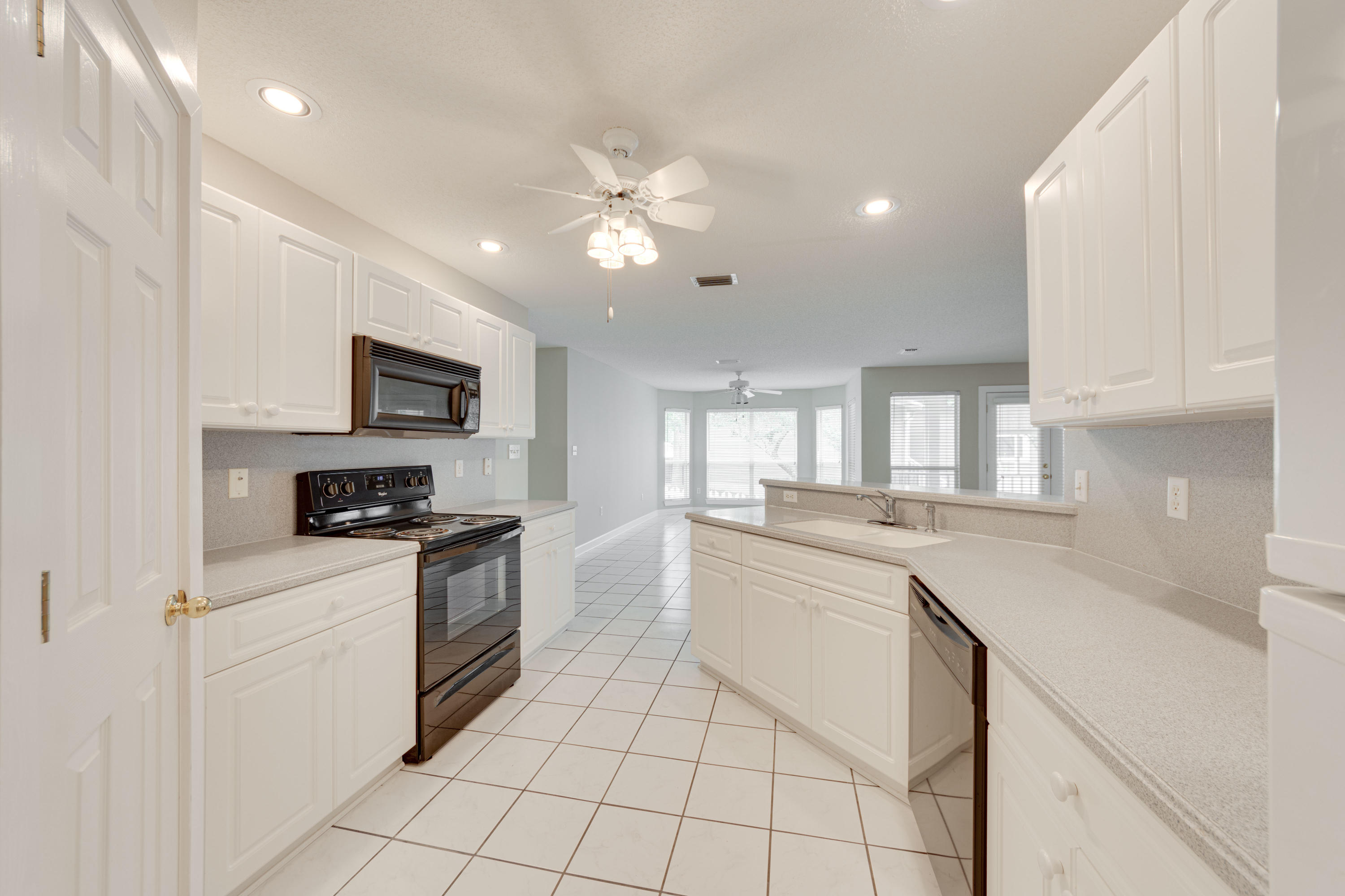 135 Gulfwinds Way Santa Rosa Beach, FL 32459 - Photo 40 of 51 a kitchen with white cabinets appliances and sink