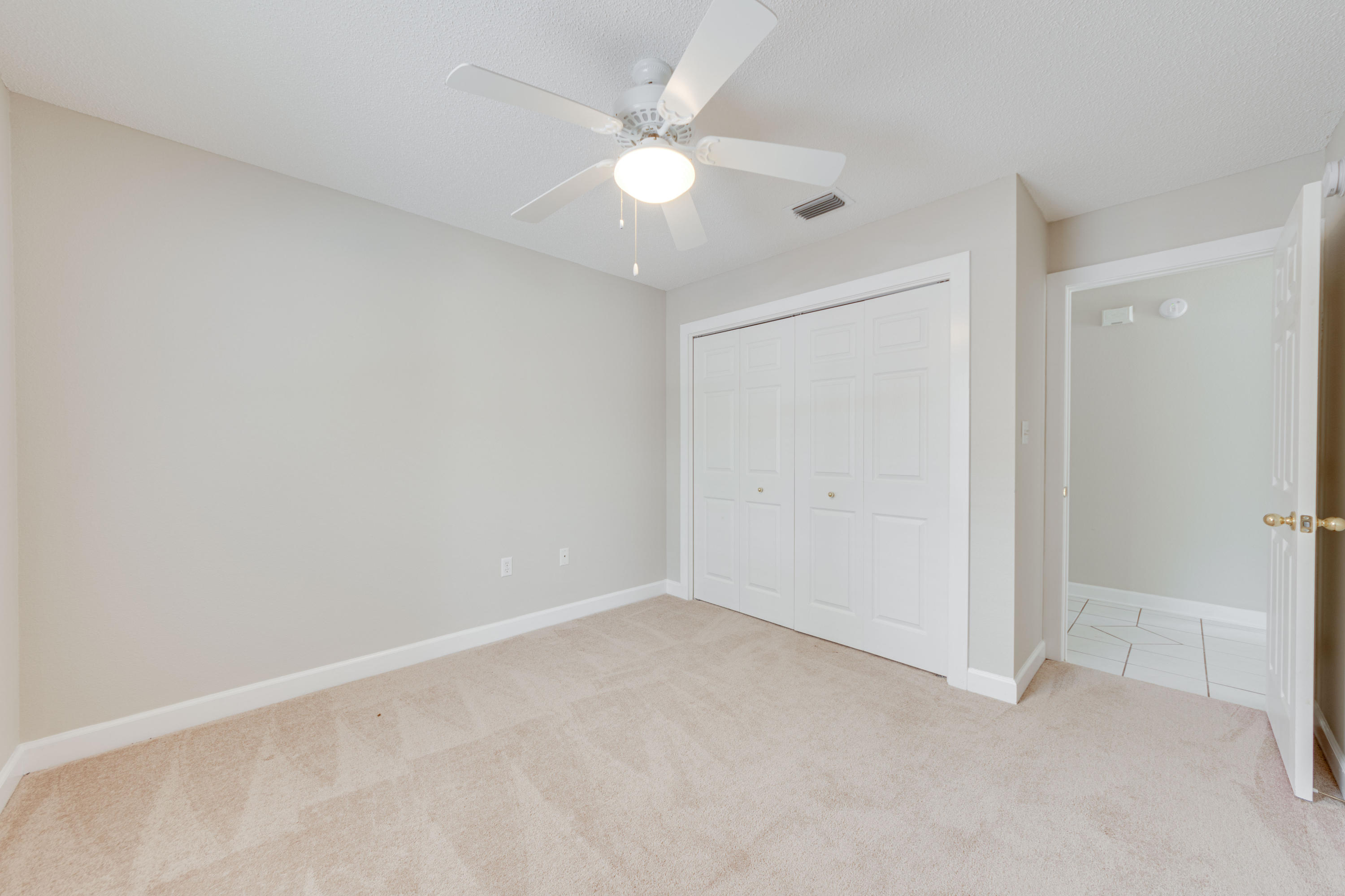 135 Gulfwinds Way Santa Rosa Beach, FL 32459 - Photo 44 of 51 an empty room with a ceiling fan and a window