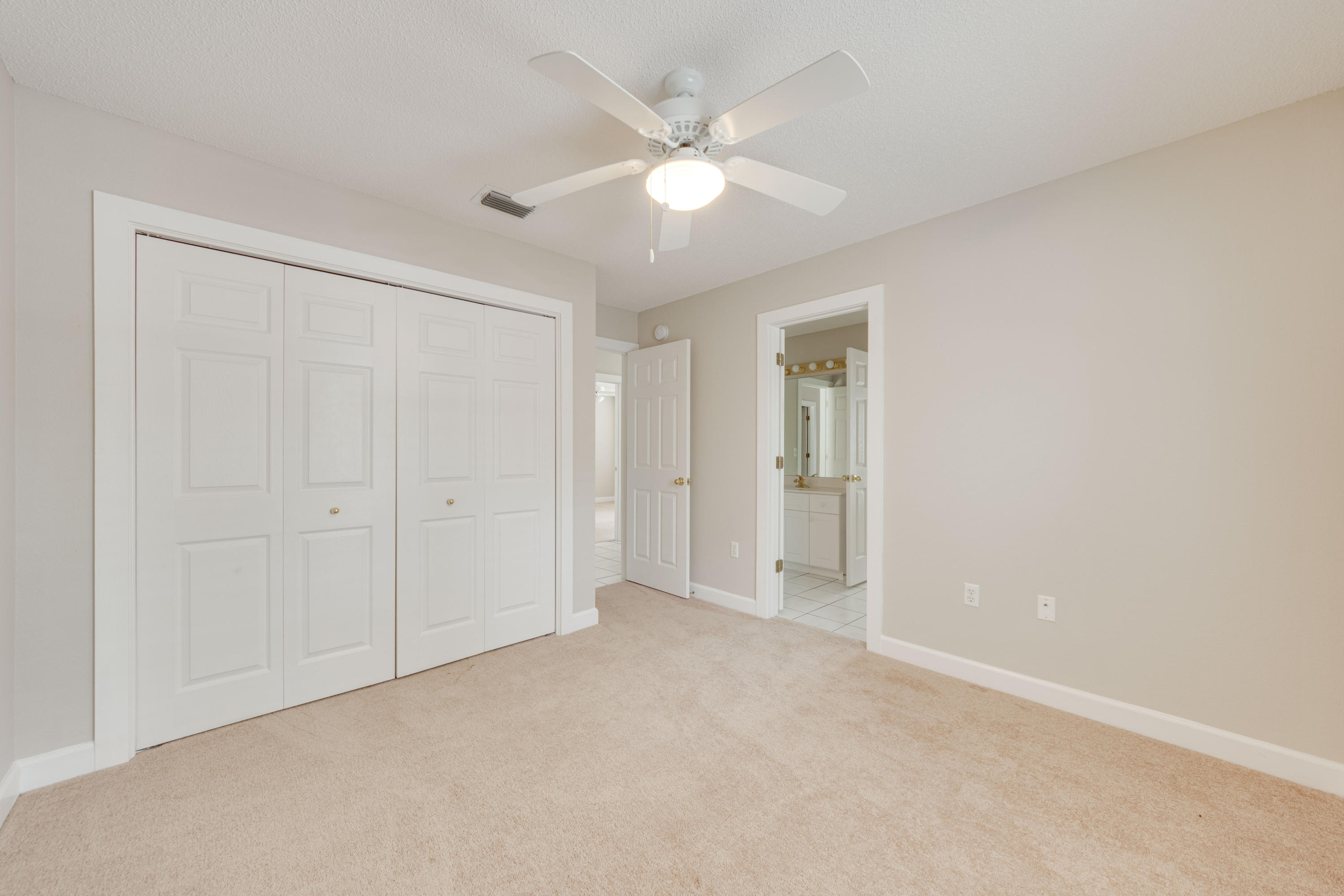 135 Gulfwinds Way Santa Rosa Beach, FL 32459 - Photo 45 of 51 an empty room with closet and ceiling fan