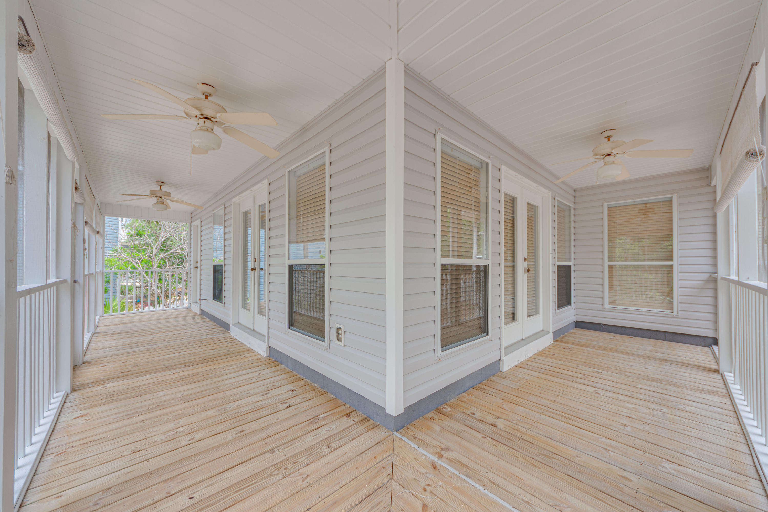 135 Gulfwinds Way Santa Rosa Beach, FL 32459 - Photo 48 of 51 a view of a porch with wooden floor and balcony
