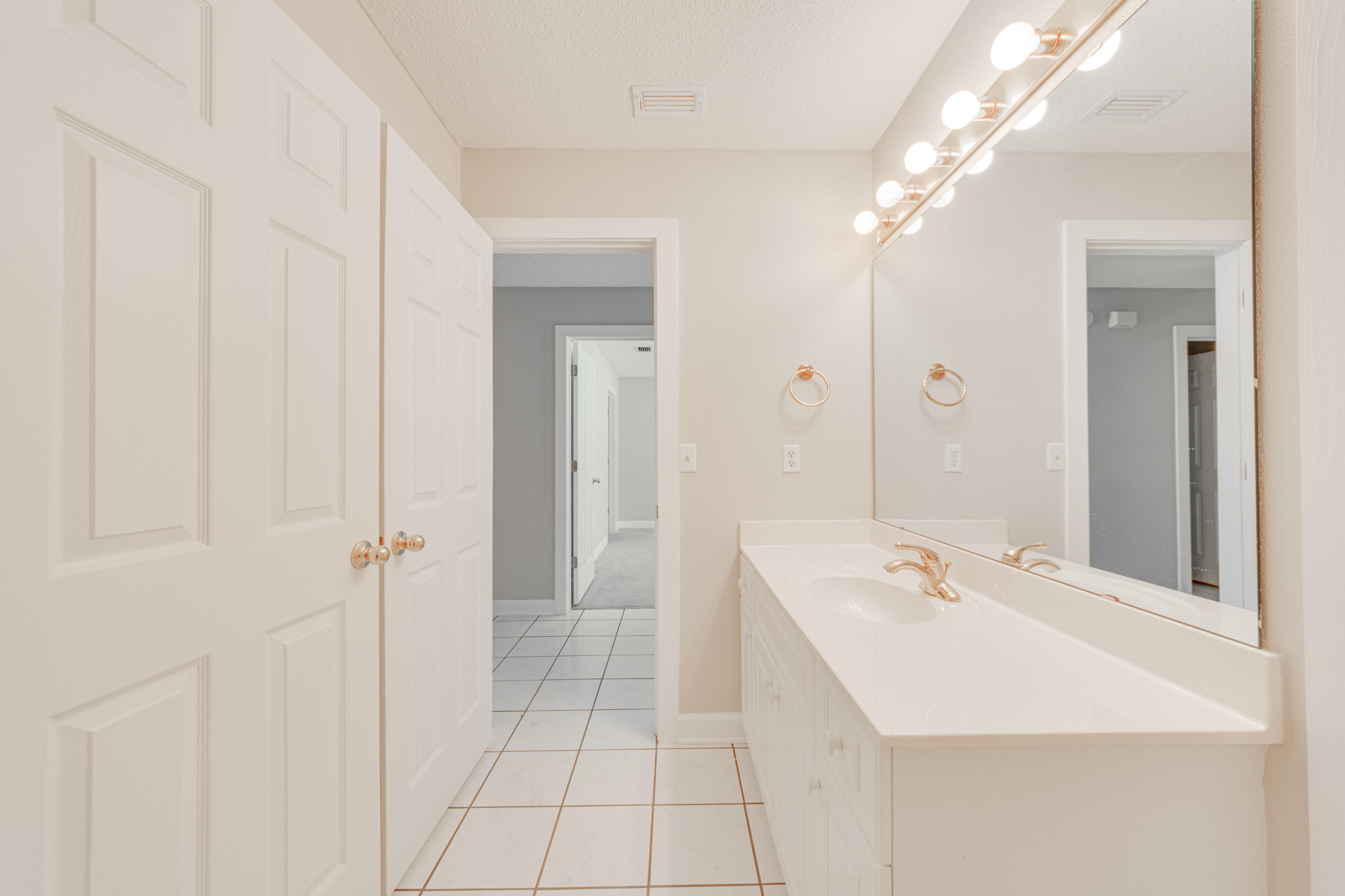 135 Gulfwinds Way Santa Rosa Beach, FL 32459 - Photo 9 of 51 a bathroom with a sink a mirror and a shower