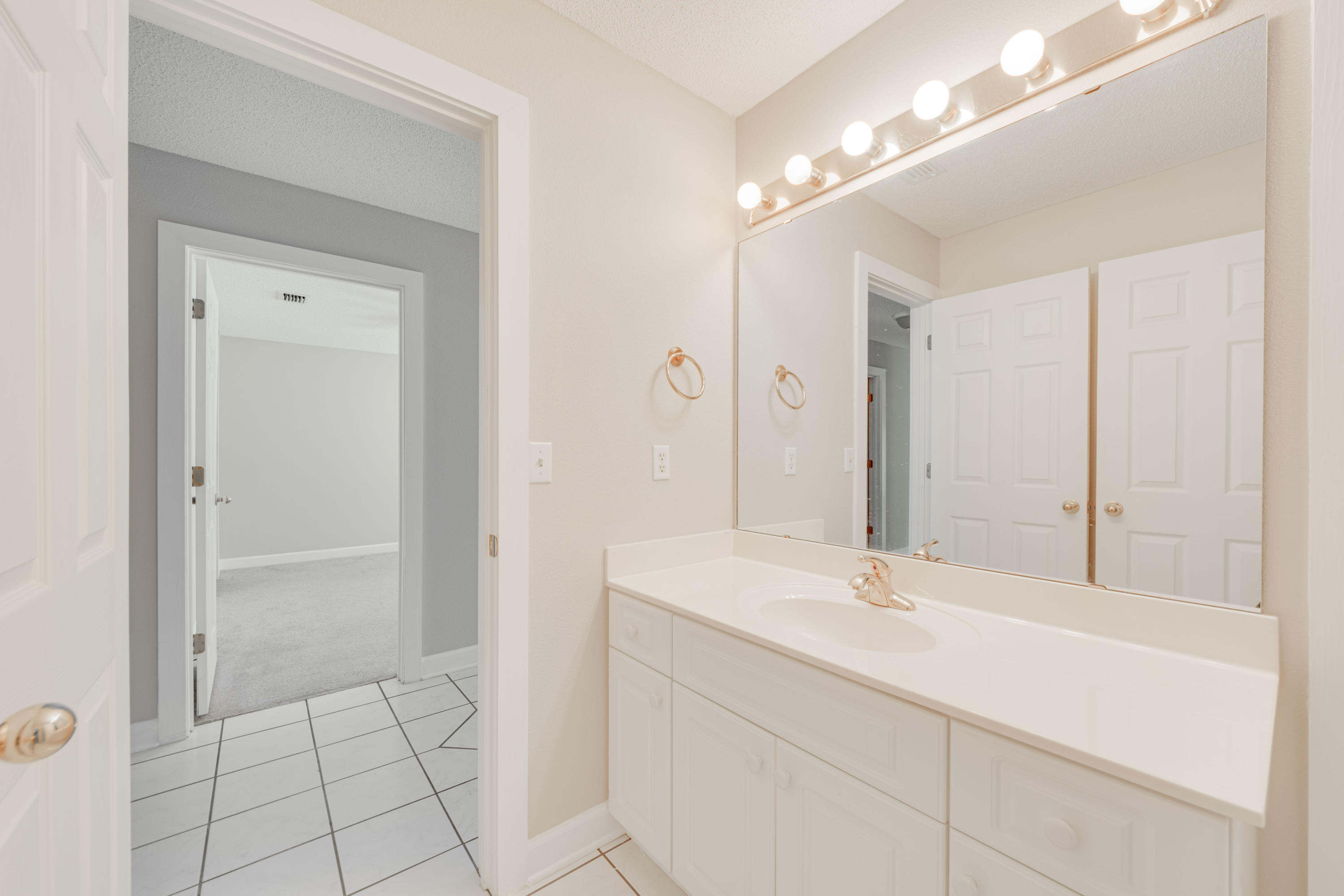 135 Gulfwinds Way Santa Rosa Beach, FL 32459 - Photo 10 of 51 a bathroom with a sink a vanity and a mirror