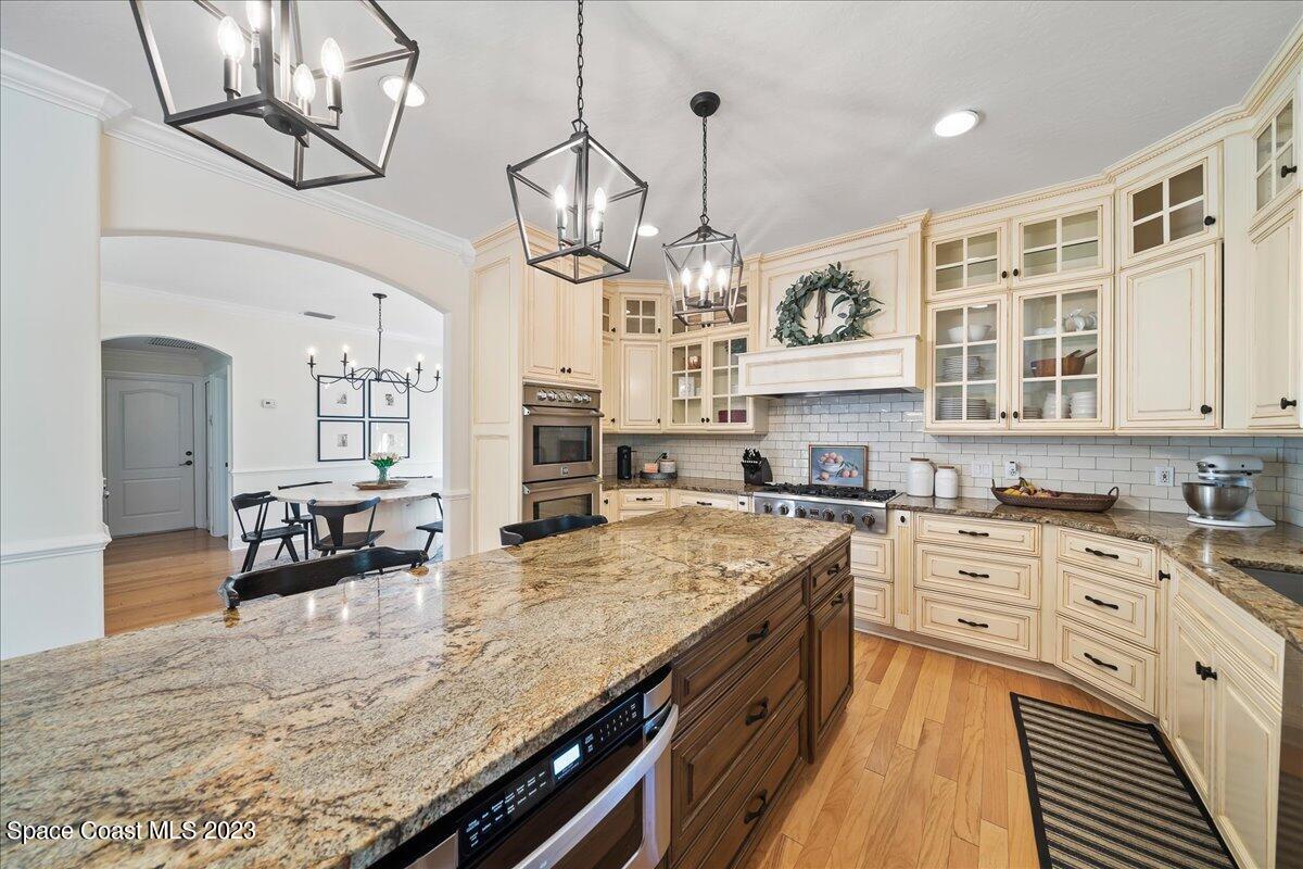 250 Baytree Drive Melbourne, FL 32940 - Photo 15 of 61 a large kitchen with stainless steel appliances granite countertop a stove and cabinets