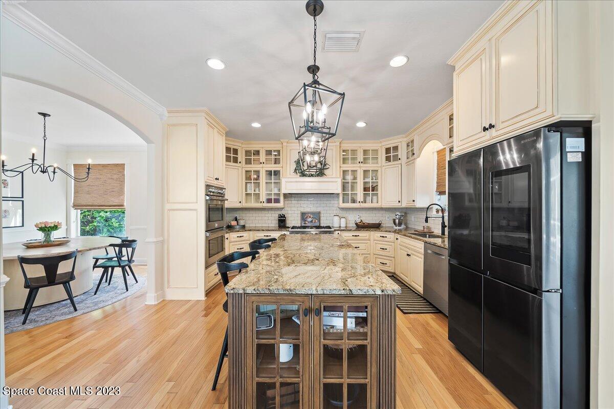 250 Baytree Drive Melbourne, FL 32940 - Photo 16 of 61 a kitchen with stainless steel appliances granite countertop a stove refrigerator and white cabinets