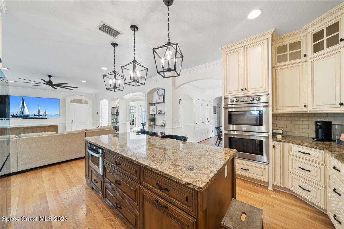 250 Baytree Drive Melbourne, FL 32940 - Photo 18 of 61 a kitchen with stainless steel appliances granite countertop a sink a stove oven a counter space and cabinets
