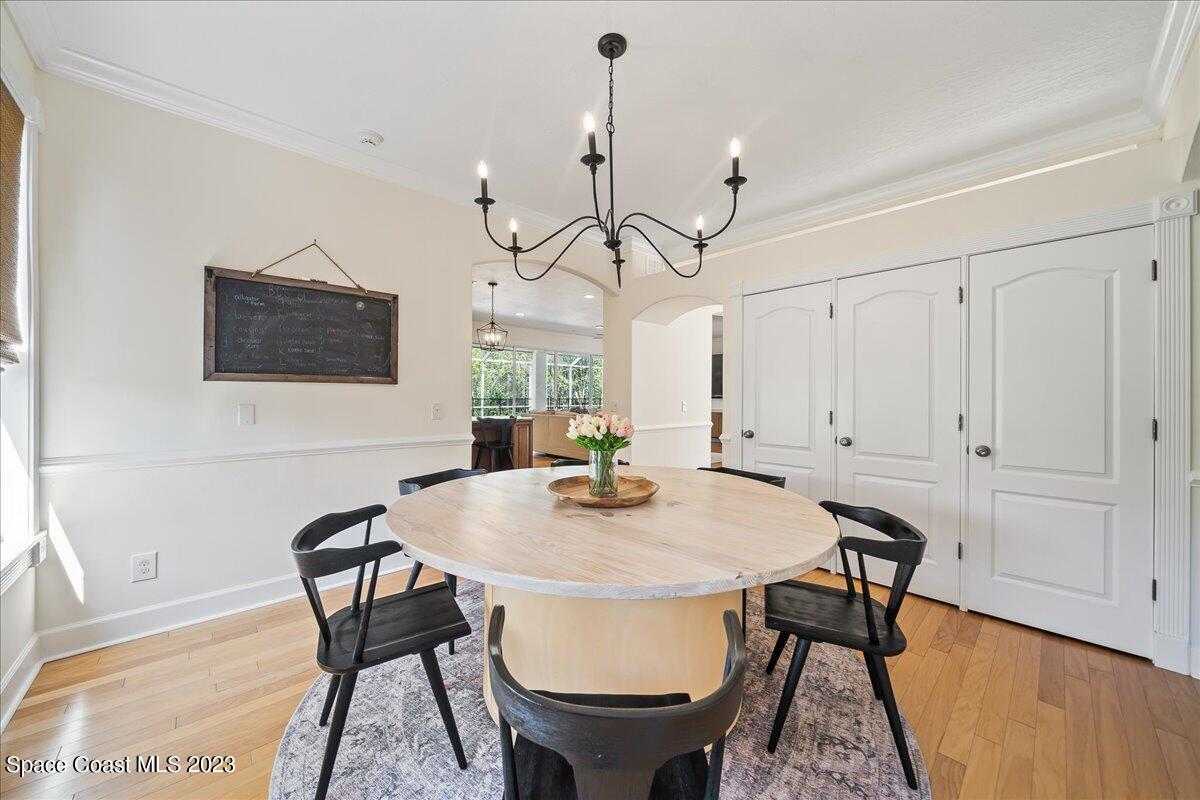 250 Baytree Drive Melbourne, FL 32940 - Photo 22 of 61 a view of a dining room with furniture and wooden floor
