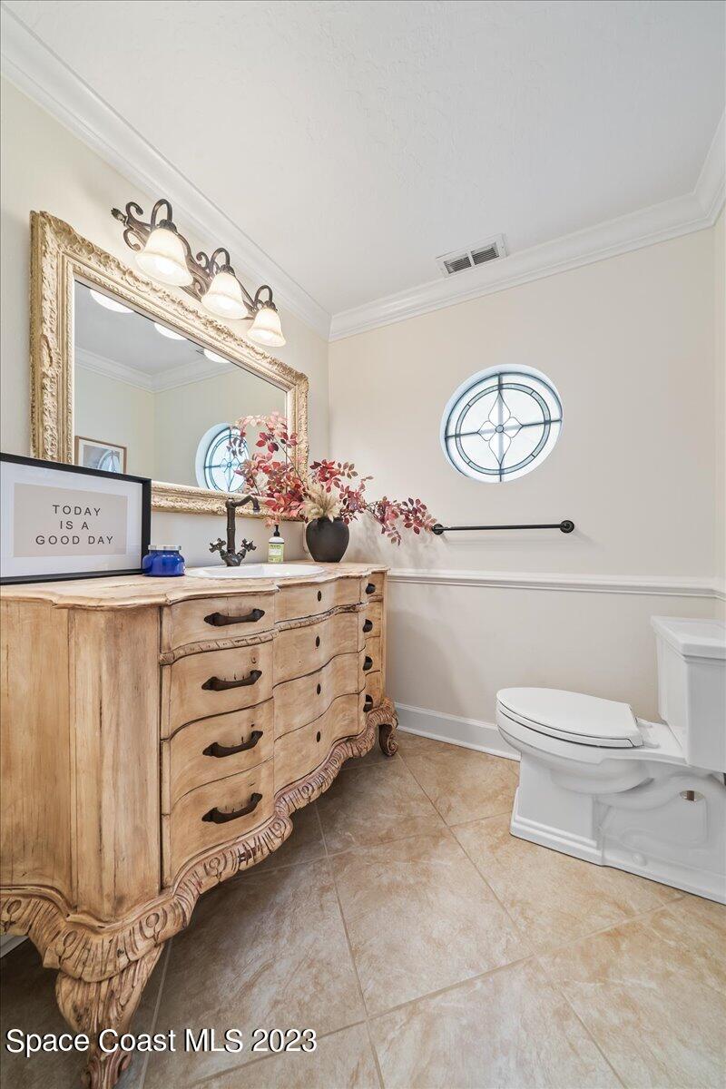 250 Baytree Drive Melbourne, FL 32940 - Photo 24 of 61 a bathroom with a toilet a sink and a mirror