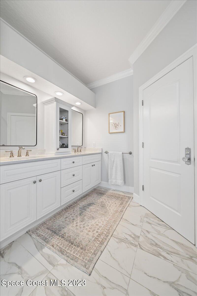 250 Baytree Drive Melbourne, FL 32940 - Photo 30 of 61 a spacious bathroom with a granite countertop sink a mirror and a