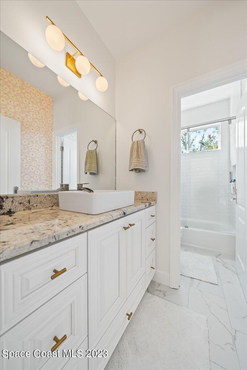 250 Baytree Drive Melbourne, FL 32940 - Photo 35 of 61 a bathroom with a granite countertop sink and a mirror
