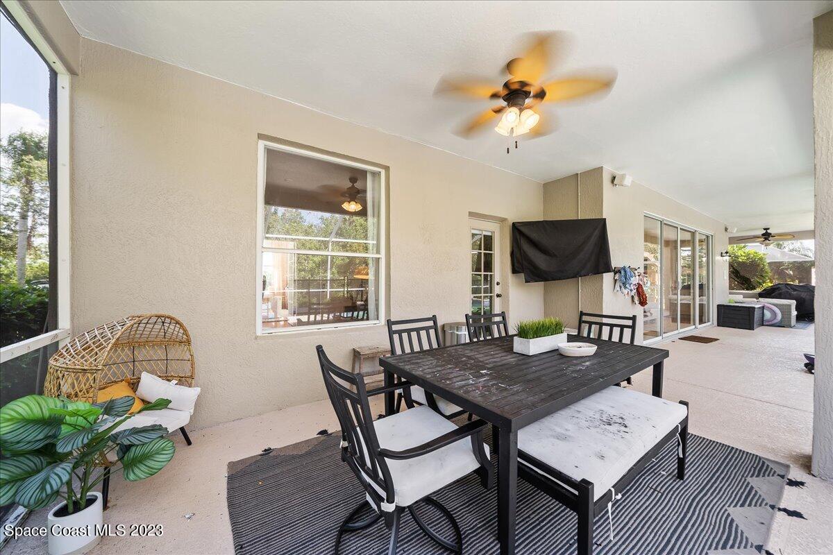 250 Baytree Drive Melbourne, FL 32940 - Photo 44 of 61 a view of a dining room with furniture and a flat screen tv
