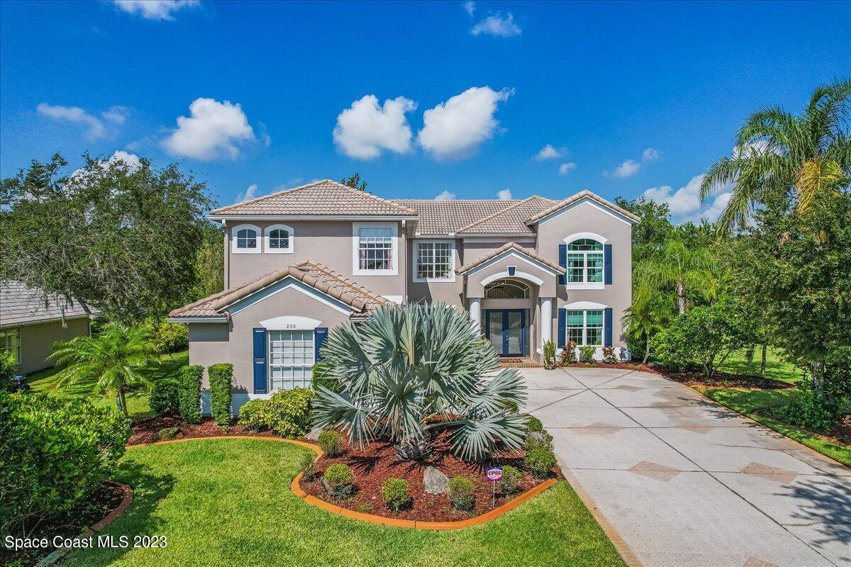 250 Baytree Drive Melbourne, FL 32940 - Photo 49 of 61 a front view of a house with a yard and potted plants