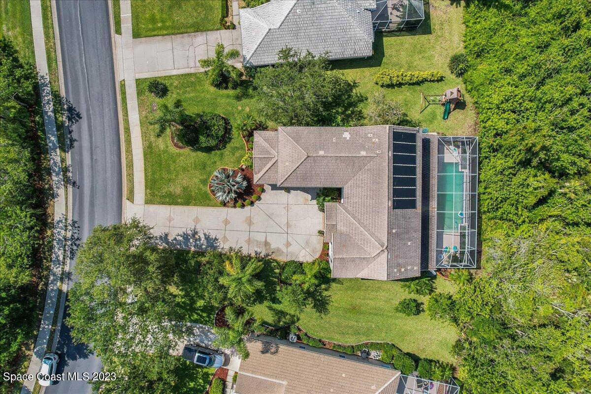 250 Baytree Drive Melbourne, FL 32940 - Photo 51 of 61 an aerial view of a house with a yard and garden