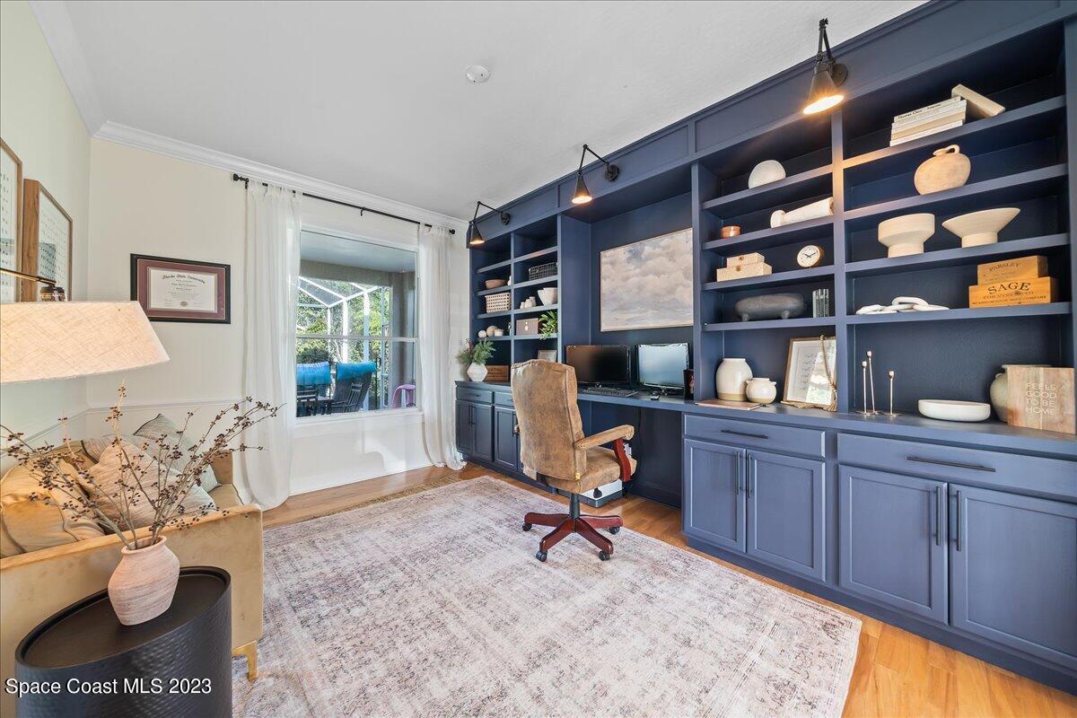 250 Baytree Drive Melbourne, FL 32940 - Photo 7 of 61 a view of a workspace with furniture and a potted plant
