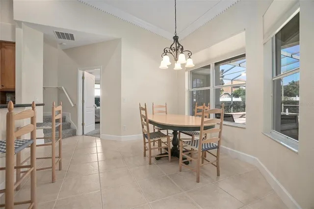 a view of a dining room with furniture and a chandelier