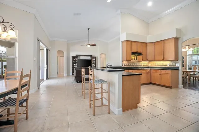 a kitchen with stainless steel appliances granite countertop a stove top oven a sink dishwasher and a refrigerator with cabinets