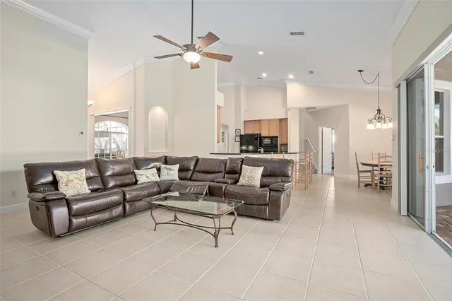 a living room with furniture and a chandelier
