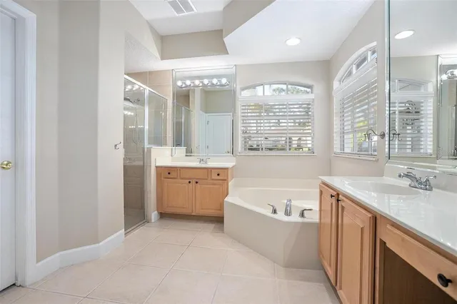 a view of a bathroom with a tub sink and mirror