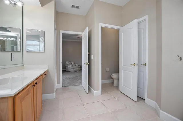 a bathroom with a granite countertop sink a toilet and a shower