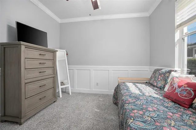 a bedroom with a bed and a flat tv screen