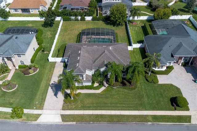 an aerial view of a house with garden space and a swimming pool